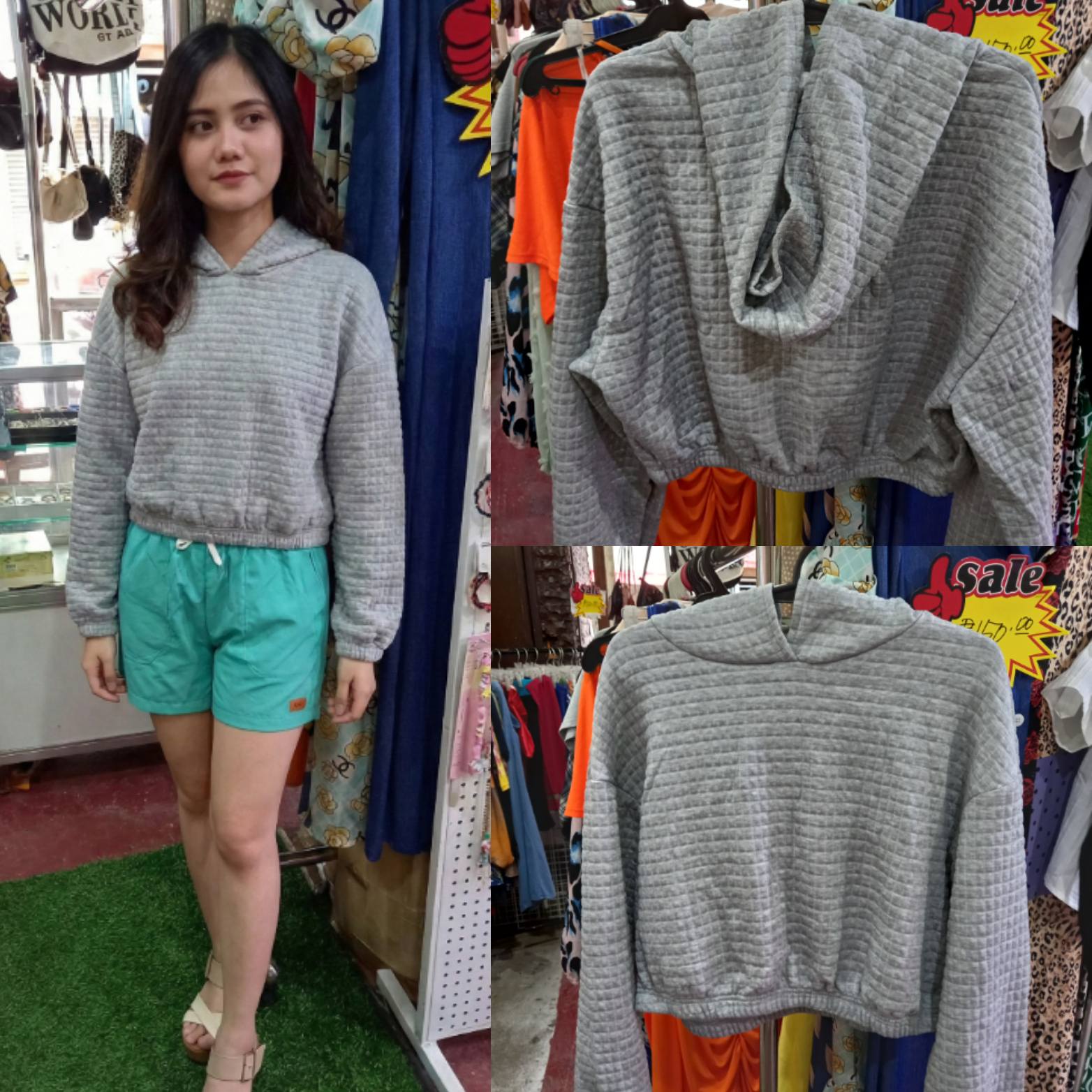 Women Grey Quilted Cropped Textured Hoodie displayed on a model with green shorts in a colorful shop setting.