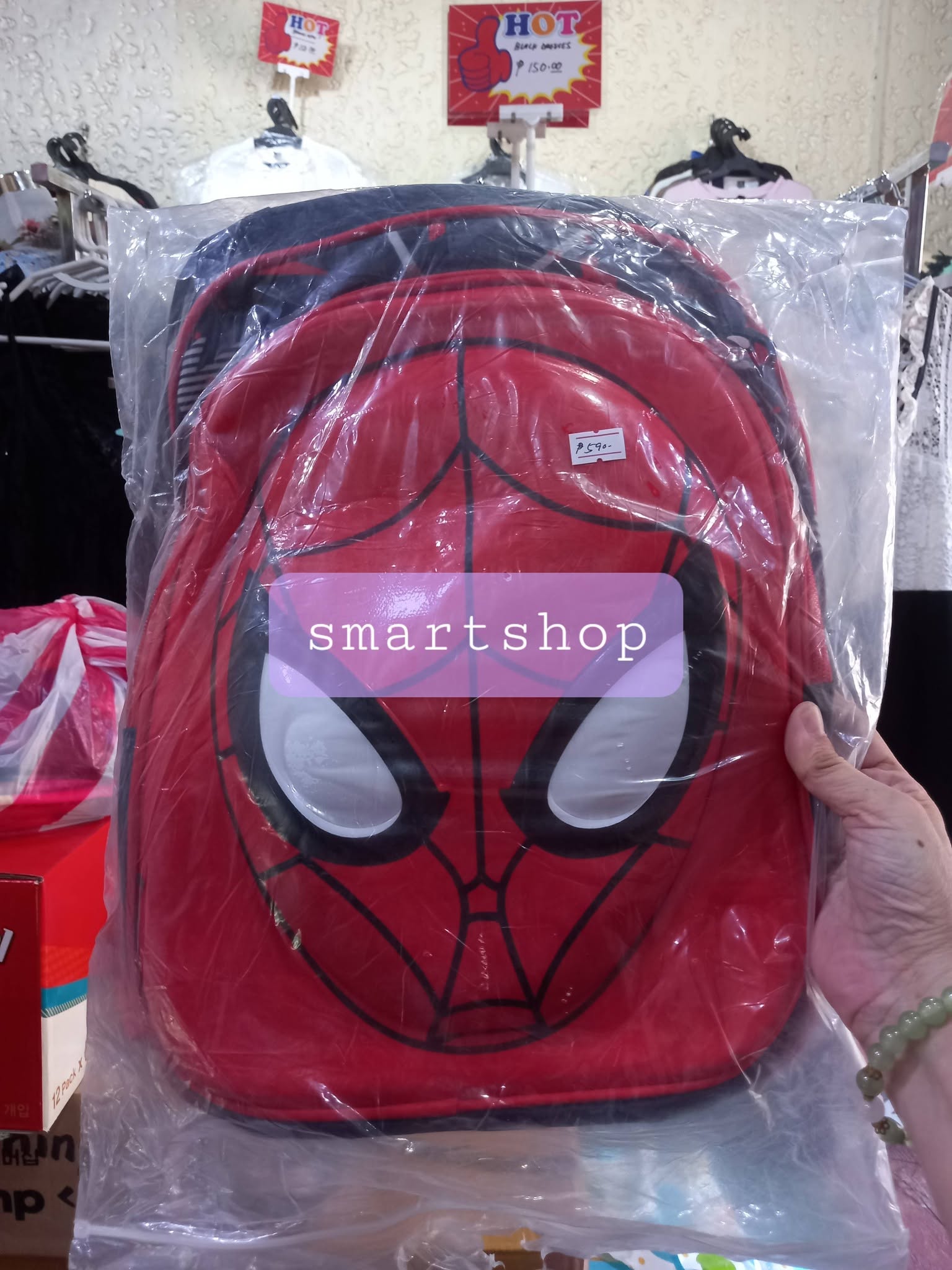 Front view of a 16-inch red Spiderman superhero backpack for kids in clear packaging" to improve search accessibility.