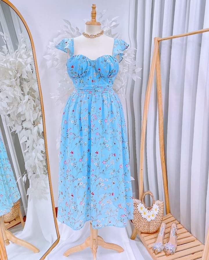Sky Blue Floral Padded Chiffon Midi Dress with floral accents and accessories.